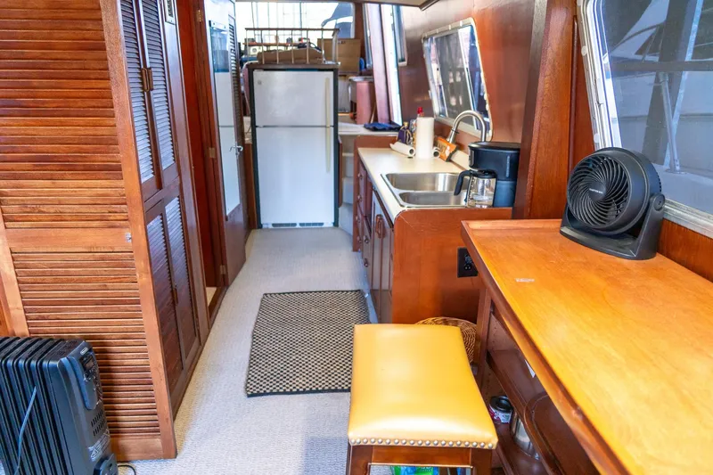 Slide: The Image of Interior of 1974 Boatel 47 Islander with kitchenette and wooden cabinetry. - 18