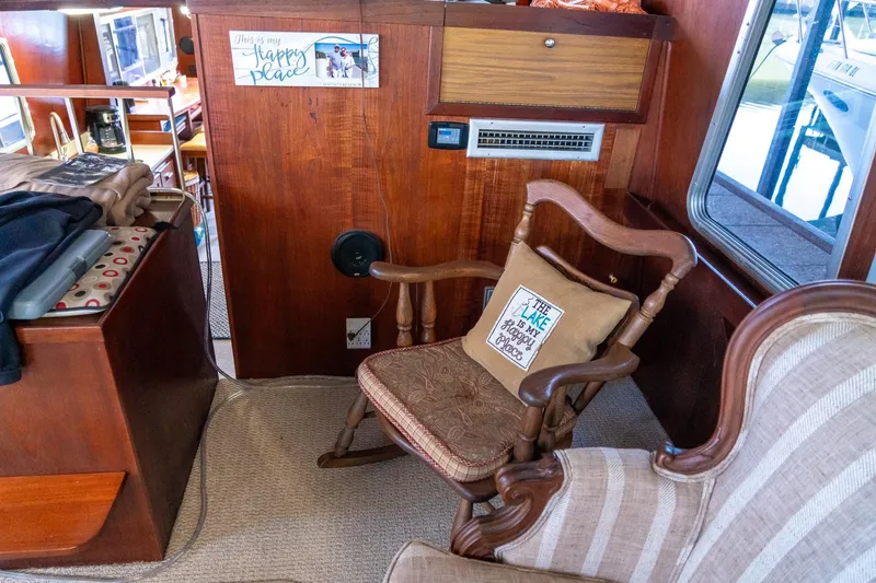 Slide: The Image of Interior of 1974 Boatel 47 Islander with cozy seating and decorative pillows. - 21