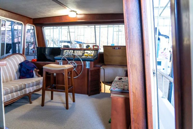 Slide: The Image of 1974 Boatel 47 Islander interior with helm, seating, and vintage decor. - 22