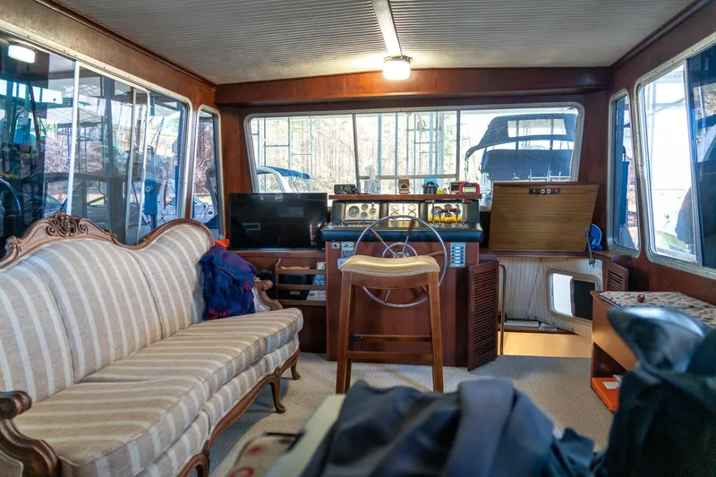 Slide: The Image of Interior of a 1974 Boatel 47 Islander with vintage decor and steering wheel. - 23