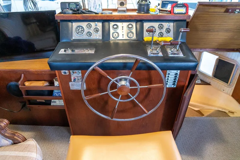 Slide: The Image of Helm of 1974 Boatel 47 Islander with steering wheel and control panel. - 24