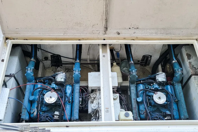 Slide: The Image of Engine compartment of a 1974 Boatel 47 Islander with dual blue engines. - 31