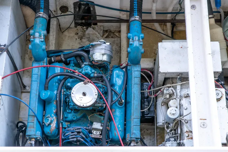 Slide: The Image of Engine compartment of a 1974 Boatel 47 Islander with visible blue machinery. - 32