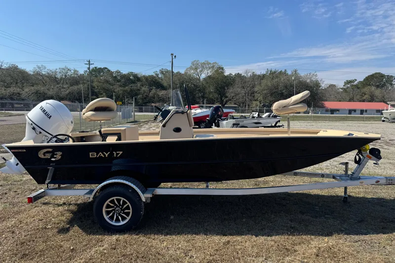 The Image of 2026 G3 Bay 17 boat on trailer, featuring Yamaha engine, parked outdoors. - 1