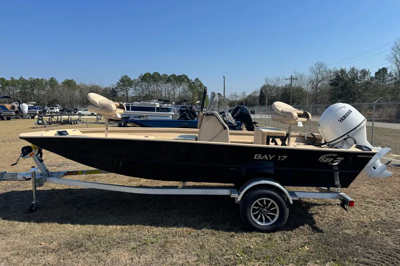 Slide: The Image of 2026 G3 Bay 17 boat on trailer with Yamaha outboard motor, parked outdoors. - 3
