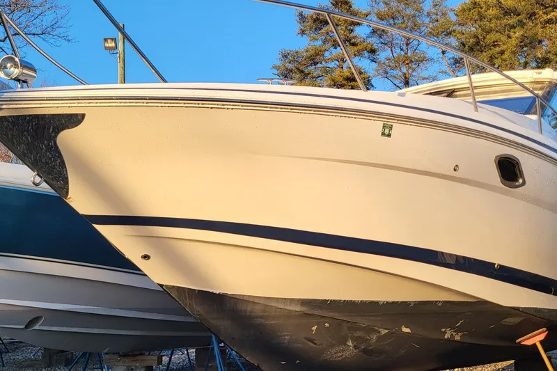 The Image of 2018 Regal 35 Sport Coupe boat in dry dock, side view with clear blue sky. - 0