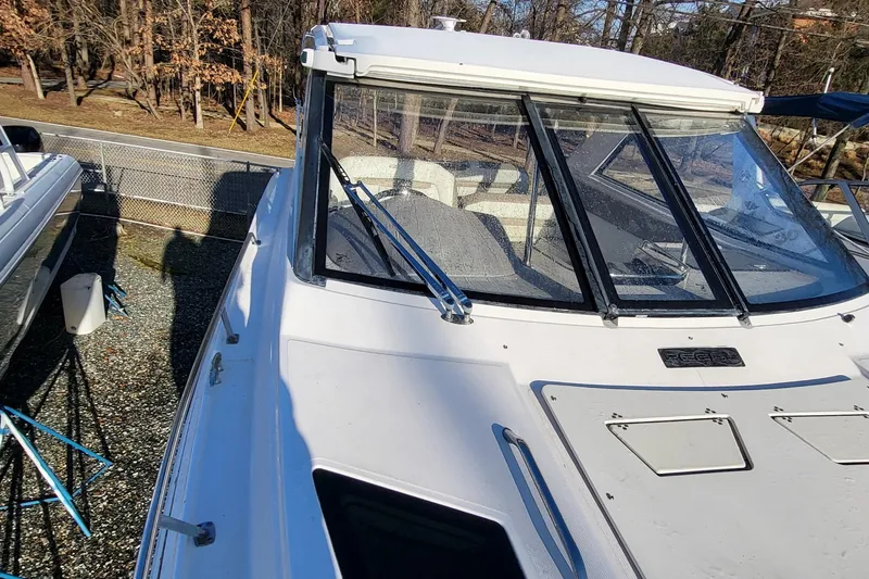 Slide: The Image of 2018 Regal 35 Sport Coupe boat with sleek design, docked outdoors. - 10