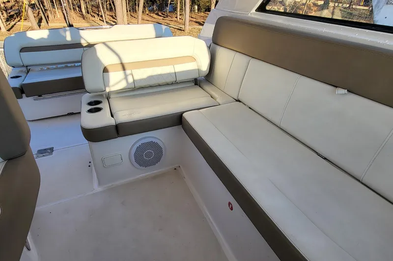 Slide: The Image of Luxurious seating area on 2018 Regal 35 Sport Coupe boat, featuring beige upholstery. - 17