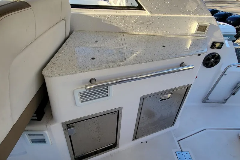 Slide: The Image of 2018 Regal 35 Sport Coupe interior with wet bar and storage compartments. - 18