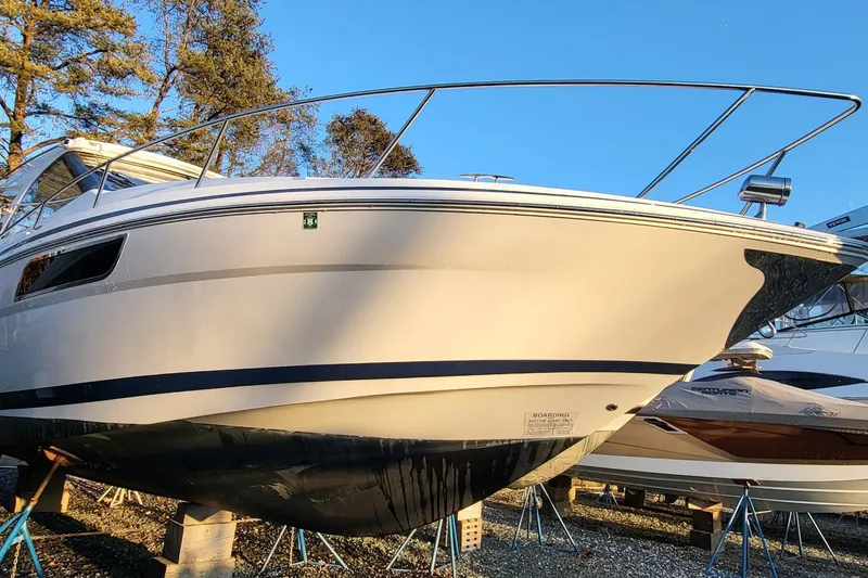 Slide: The Image of 2018 Regal 35 Sport Coupe boat on stands, side view, outdoors. - 2