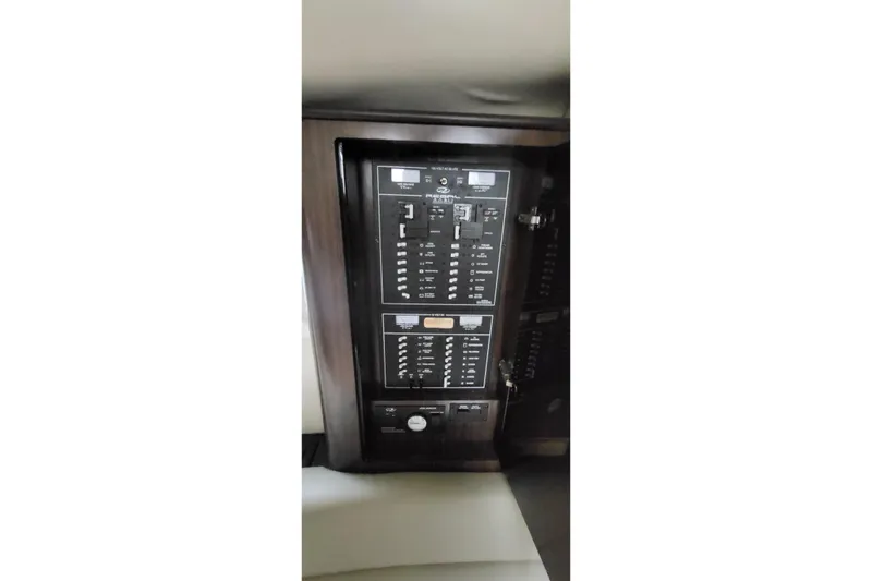 Slide: The Image of Control panel inside 2018 Regal 35 Sport Coupe boat, featuring switches and indicators. - 28