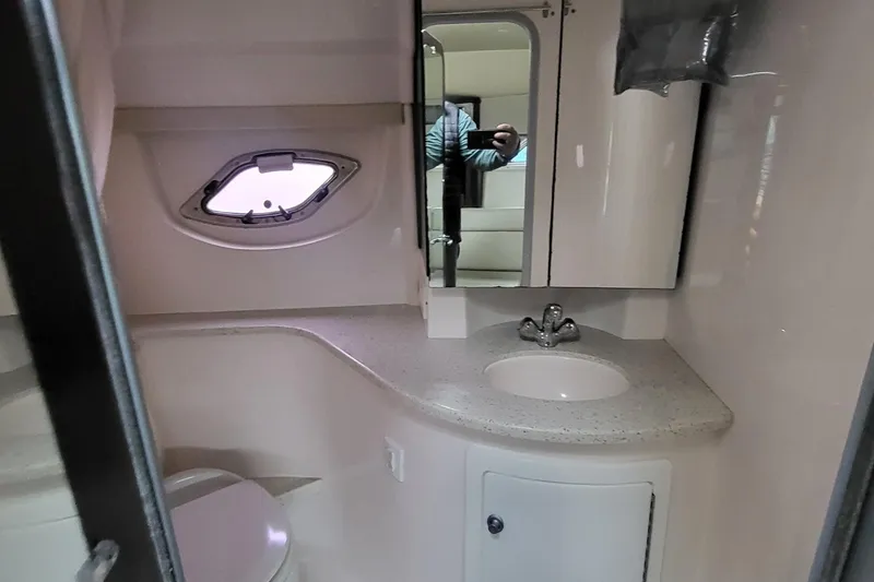 Slide: The Image of 2018 Regal 35 Sport Coupe bathroom with sink, mirror, and porthole window. - 29