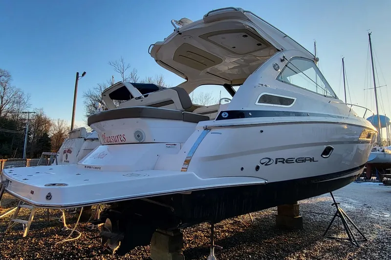 Slide: The Image of 2018 Regal 35 Sport Coupe boat on dry dock, rear view, showcasing sleek design. - 3