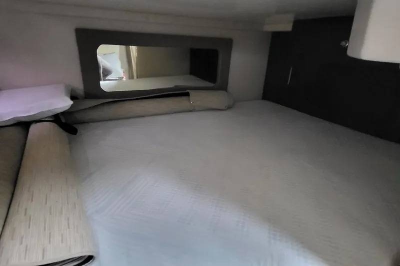 Slide: The Image of 2018 Regal 35 Sport Coupe cabin interior with bed and mirror. - 30