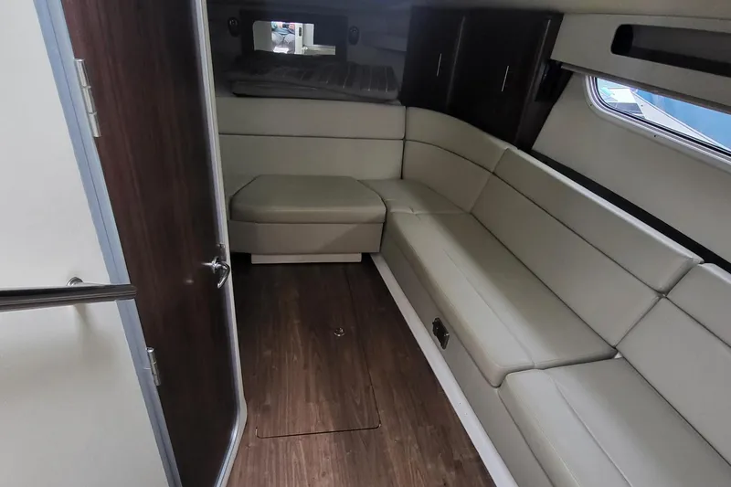 Slide: The Image of 2018 Regal 35 Sport Coupe interior with beige seating and wood flooring. - 31