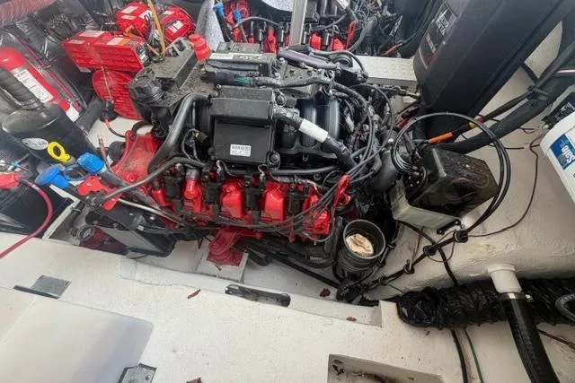 Slide: The Image of Engine compartment of a 2018 Regal 35 Sport Coupe with visible components and wiring. - 35