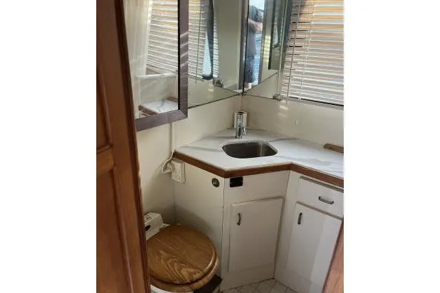 Slide: The Image of Compact bathroom in 1988 Kadey Krogen 42 yacht with sink, toilet, and wooden accents. - 14
