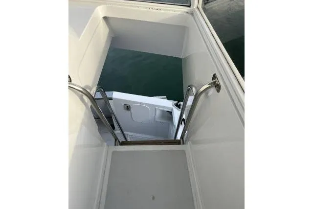 Slide: The Image of Stairway on 1988 Kadey Krogen 42 yacht, featuring sleek white design and stainless steel railings. - 18