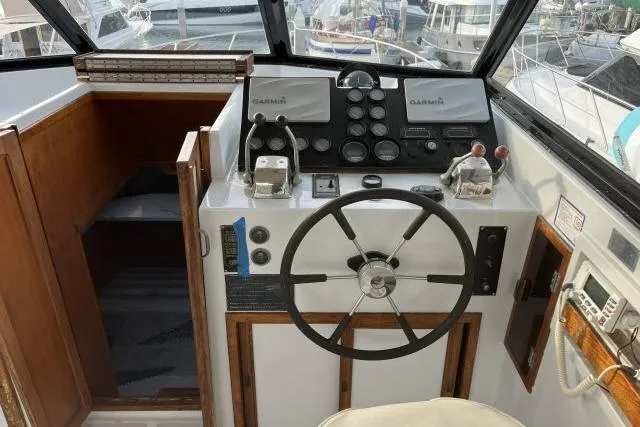 Slide: The Image of 1988 Kadey Krogen 42 boat helm with steering wheel and navigation instruments. - 20