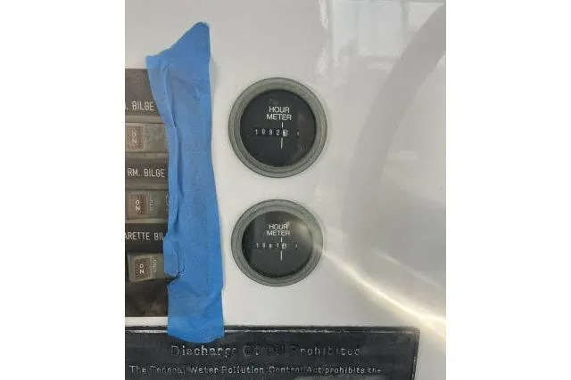 Slide: The Image of Hour meters on a 1988 Kadey Krogen 42 boat dashboard with blue tape. - 21