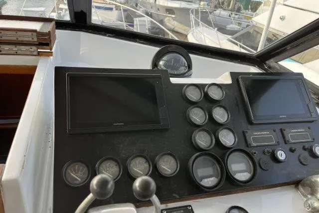 Slide: The Image of Control panel of a 1988 Kadey Krogen 42 boat with navigation screens and gauges. - 22