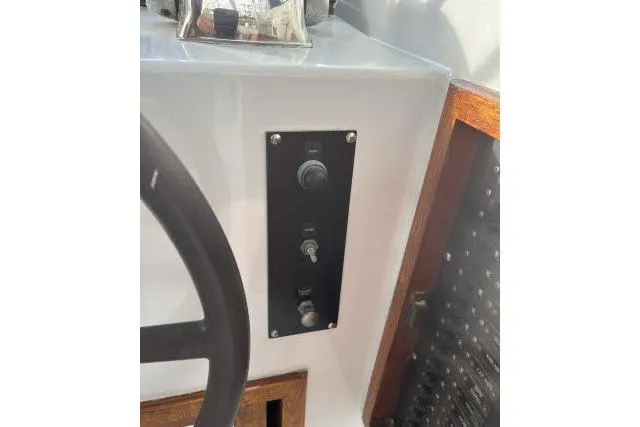 Slide: The Image of Control panel on 1988 Kadey Krogen 42 boat, featuring switches and steering wheel. - 25