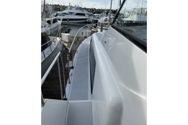 Slide: The Image of 1988 Kadey Krogen 42 yacht docked, showcasing sleek deck and marina view. - 28