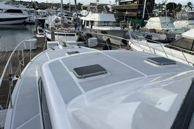 Slide: The Image of 1988 Kadey Krogen 42 yacht docked in a marina, surrounded by other boats. - 29