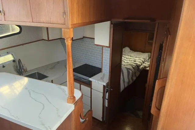 Slide: The Image of Interior of 1988 Kadey Krogen 42 yacht with kitchen and cozy sleeping area. - 3