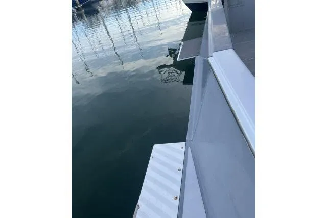 Slide: The Image of 1988 Kadey Krogen 42 yacht docked, reflecting on calm water surface. - 32