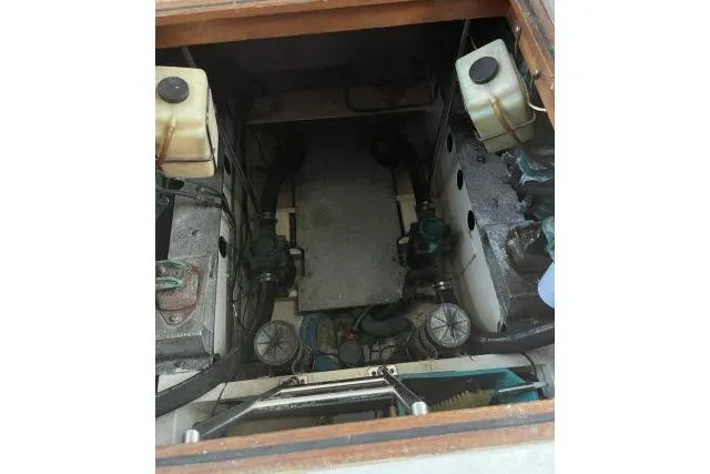 Slide: The Image of Engine compartment of 1988 Kadey Krogen 42 boat, showcasing mechanical components and storage tanks. - 33