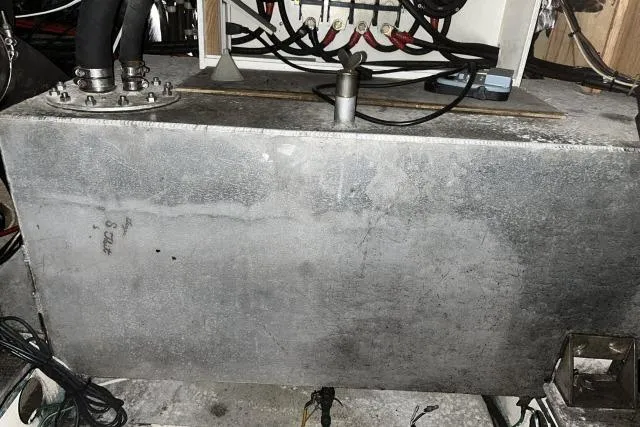 Slide: The Image of Engine room of 1988 Kadey Krogen 42 with metal tank and wiring. - 39