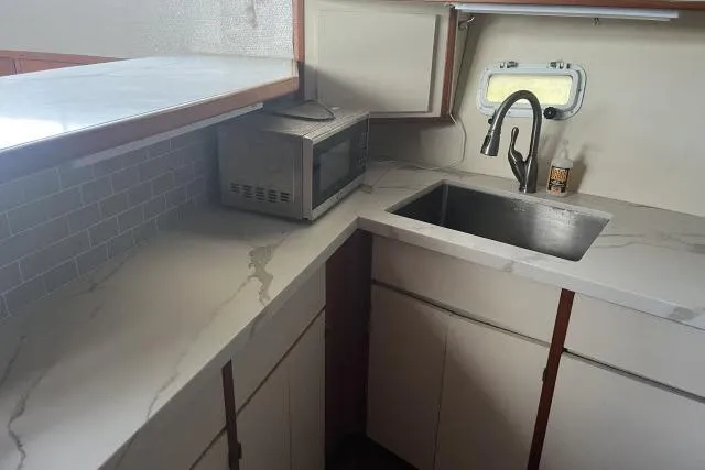 Slide: The Image of 1988 Kadey Krogen 42 yacht kitchen with marble countertops and stainless steel sink. - 4