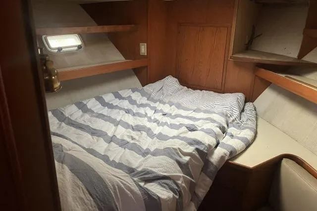 Slide: The Image of Cozy cabin interior of 1988 Kadey Krogen 42 with striped bedding and wooden accents. - 7