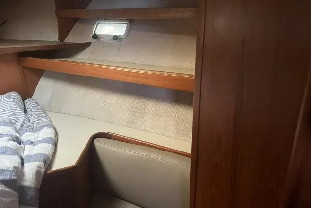 Slide: The Image of Cozy cabin interior of 1988 Kadey Krogen 42 with wooden shelves and bedding. - 8