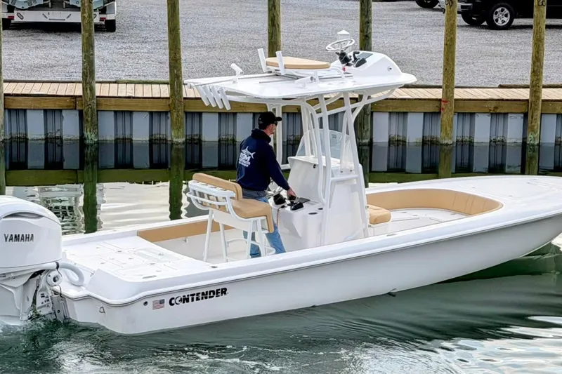 The Image of 2026 Contender 26 Bay boat on Sport Trail trailer in showroom. - 0