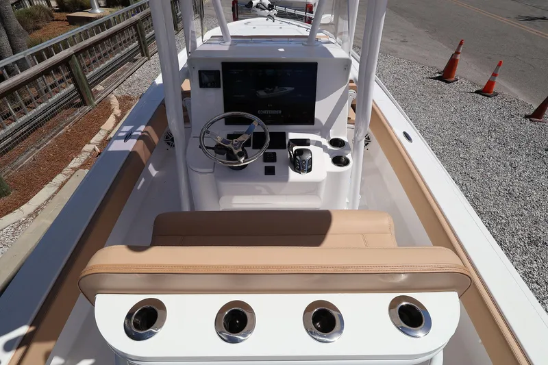 Slide: The Image of 2026 Contender 26 Bay boat interior with steering wheel and control panel. - 11