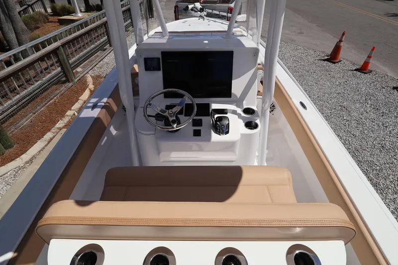 Slide: The Image of 2026 Contender 26 Bay boat interior with steering console and seating. - 13