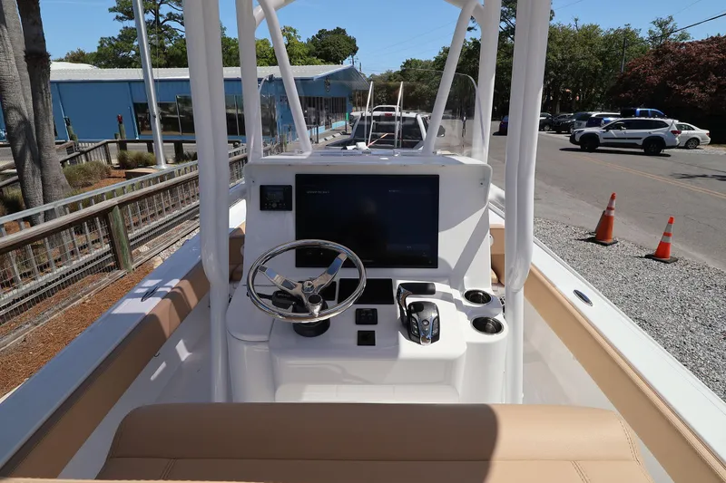 Slide: The Image of 2026 Contender 26 Bay boat dashboard with steering wheel and controls. - 14