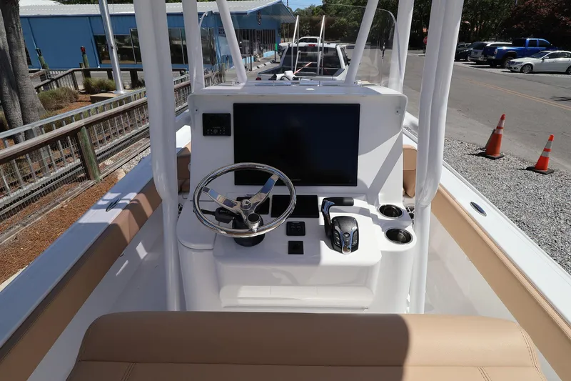 Slide: The Image of 2026 Contender 26 Bay boat dashboard with steering wheel and controls. - 15