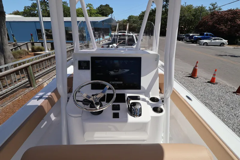 Slide: The Image of 2026 Contender 26 Bay boat dashboard with steering wheel and control panel. - 19