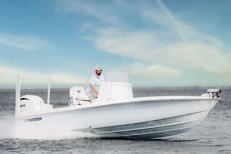 Slide: The Image of 2026 Contender 26 Bay boat with 350 HP engine in showroom. - 2