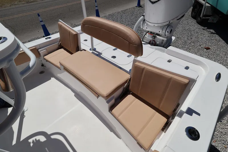 Slide: The Image of 2026 Contender 26 Bay boat seating area with tan cushions and modern design. - 20