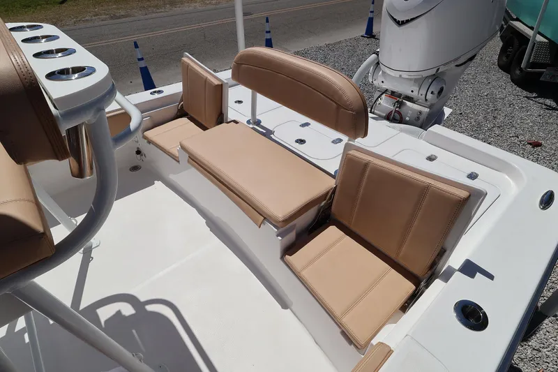 Slide: The Image of 2026 Contender 26 Bay boat interior with tan seating and rod holders. - 21
