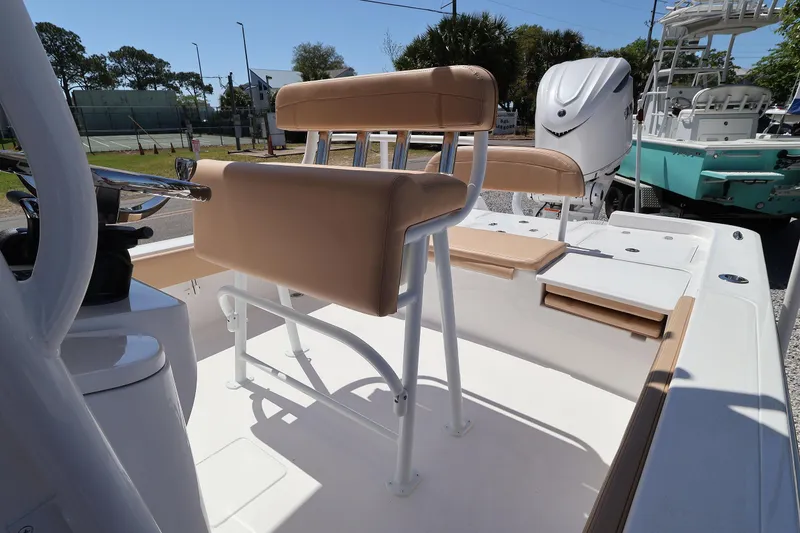 Slide: The Image of 2026 Contender 26 Bay boat interior with tan seating and white console. - 24