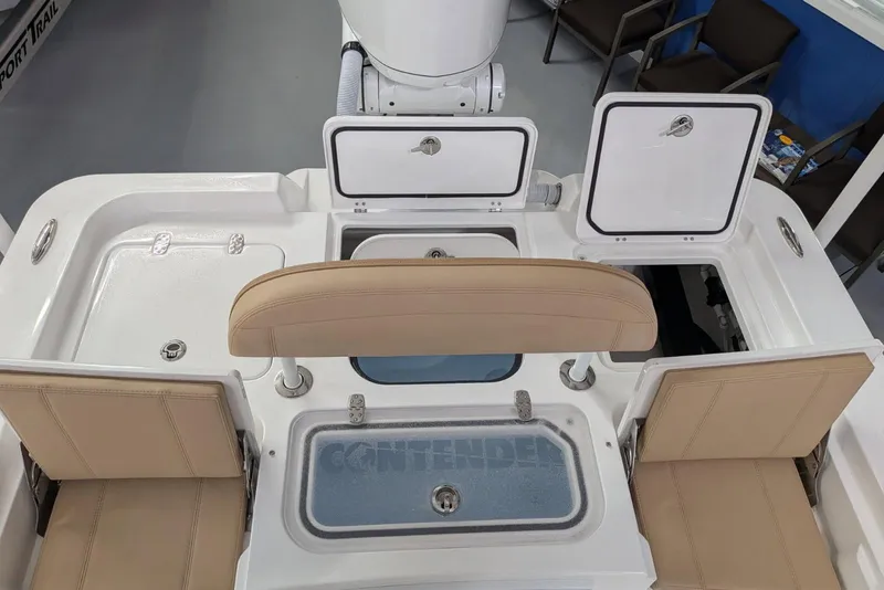 Slide: The Image of 2026 Contender 26 Bay boat interior with beige seating and storage compartments. - 27