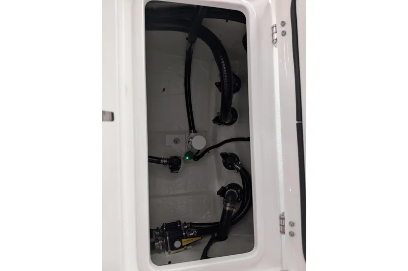 Slide: The Image of 2026 Contender 26 Bay boat interior compartment with visible wiring and components. - 29