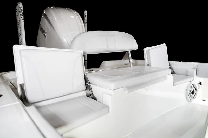 Slide: The Image of 2026 Contender 26 Bay boat interior with tan seating, displayed indoors. - 5