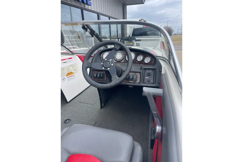 Slide: The Image of 2003 Skeeter SL 190 boat dashboard with steering wheel and instrument panel. - 4