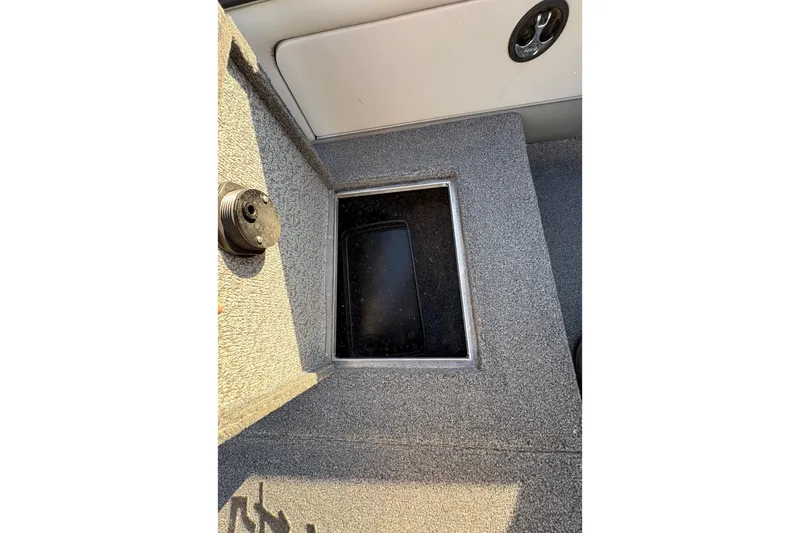 Slide: The Image of 2005 Lund 2025 Pro-V LE boat interior storage compartment with textured surface. - 17